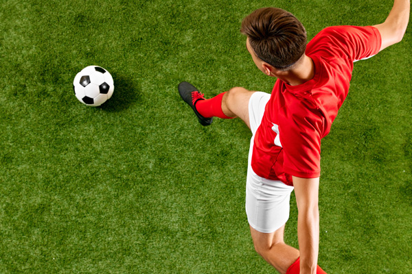 football player kicking a ball